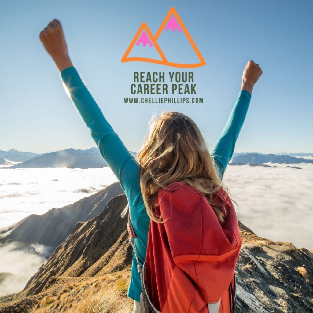 Female with arms raised overhead in victory as she stands on mountain top